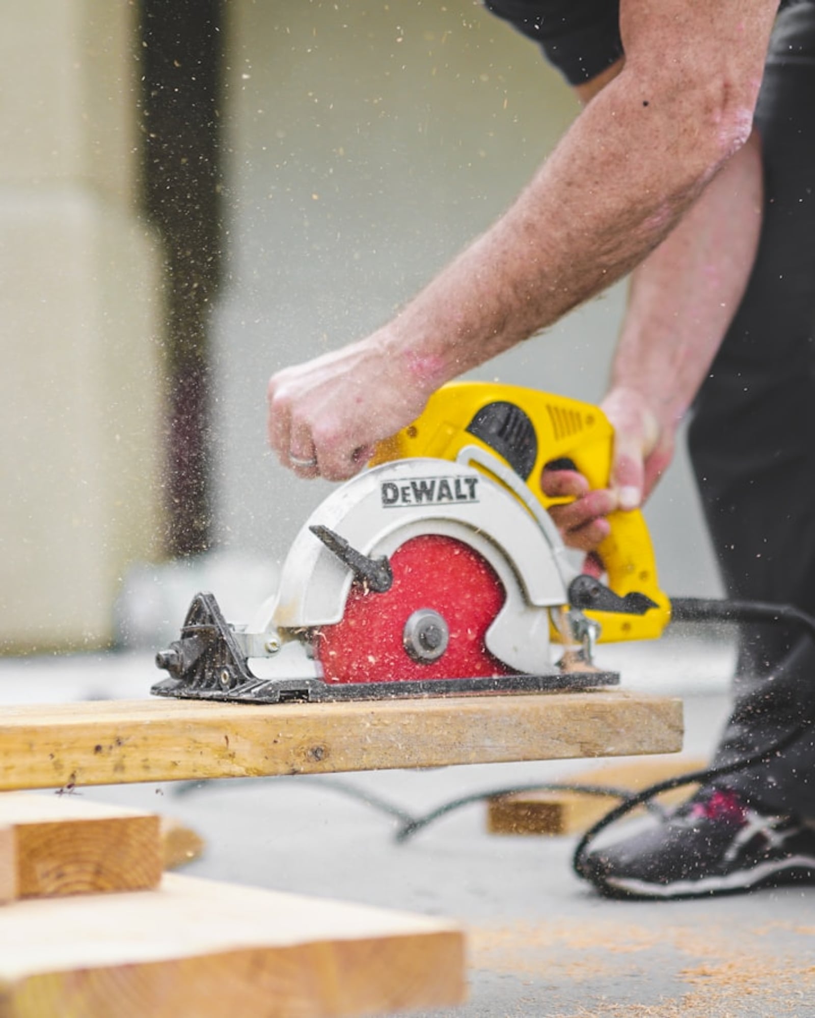 Carpenter cutting lumber with a circular saw — skilled handyman work in progress.